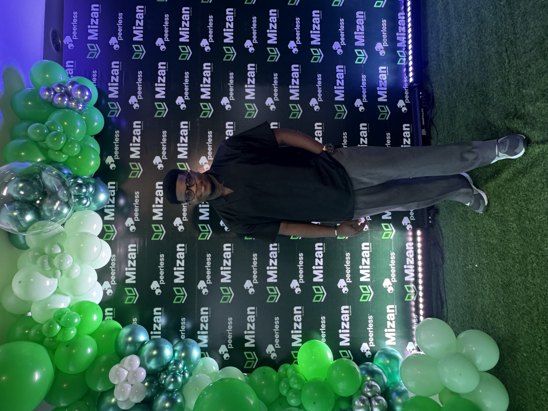 Okiki Oriola at a Peerless event, wearing glasses and a black shirt